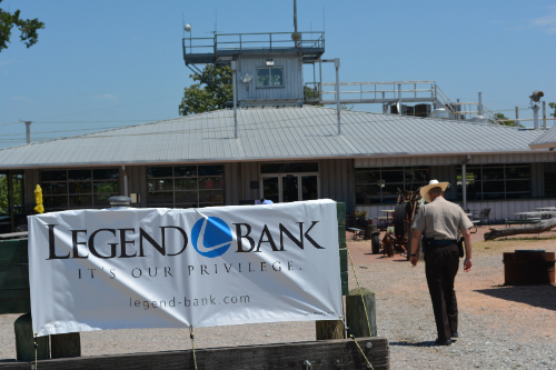 Image of Legend Bank banner and police officer walking past it