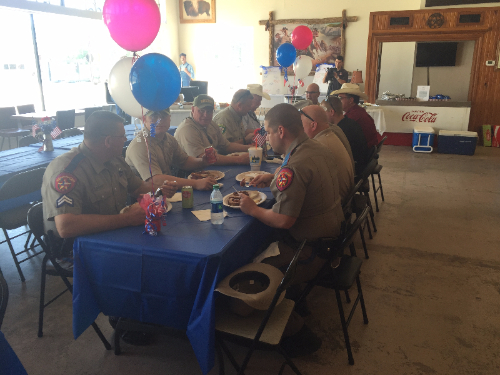 Image of several police officers enjoying a meal.